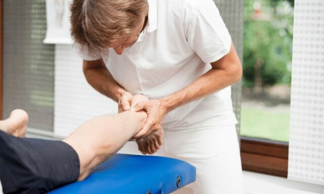 Achilles Tendon Hands Physiotherapist Treatment Stock Photo